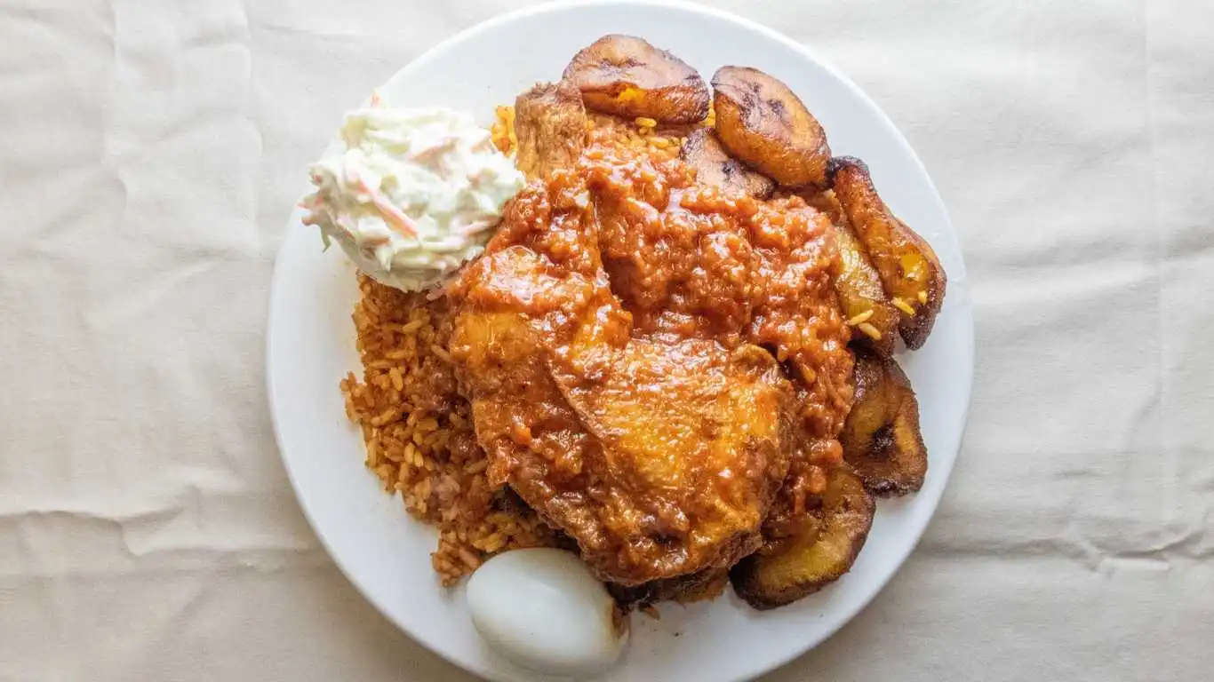Jollof Rice with Chicken, Egg and Plantain - Beloved West African staple at Atiga Restaurant Winnipeg